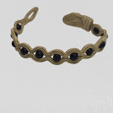 Black Onyx wrapped in golden embroidery