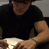 Black Onyx wrapped in dark grey embroidery