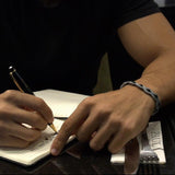 Black Onyx wrapped in dark grey embroidery